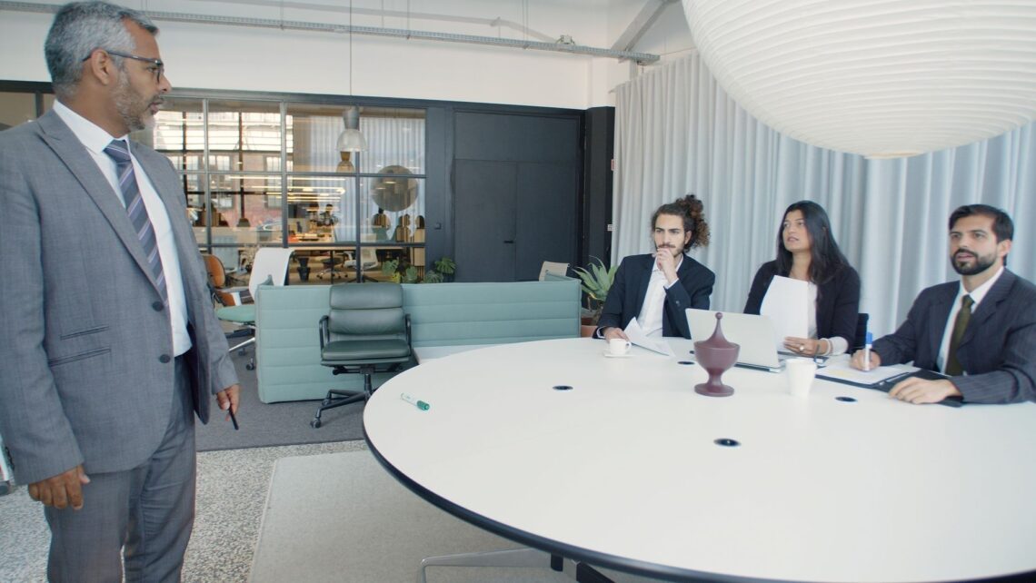 Executive team discussing strategy around a conference table